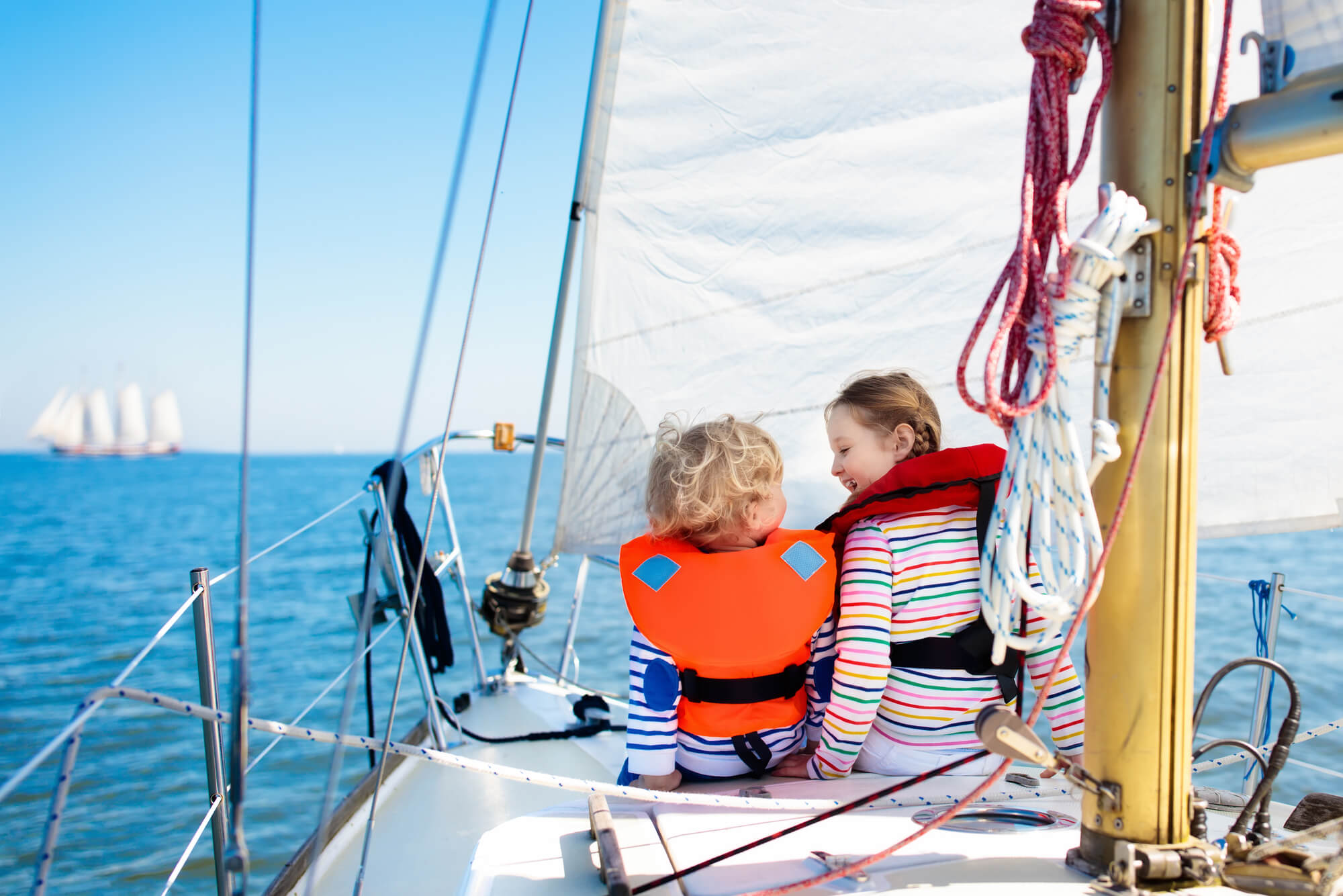 happy kids on a sailboat needing a Boat Lift in West Palm Beach