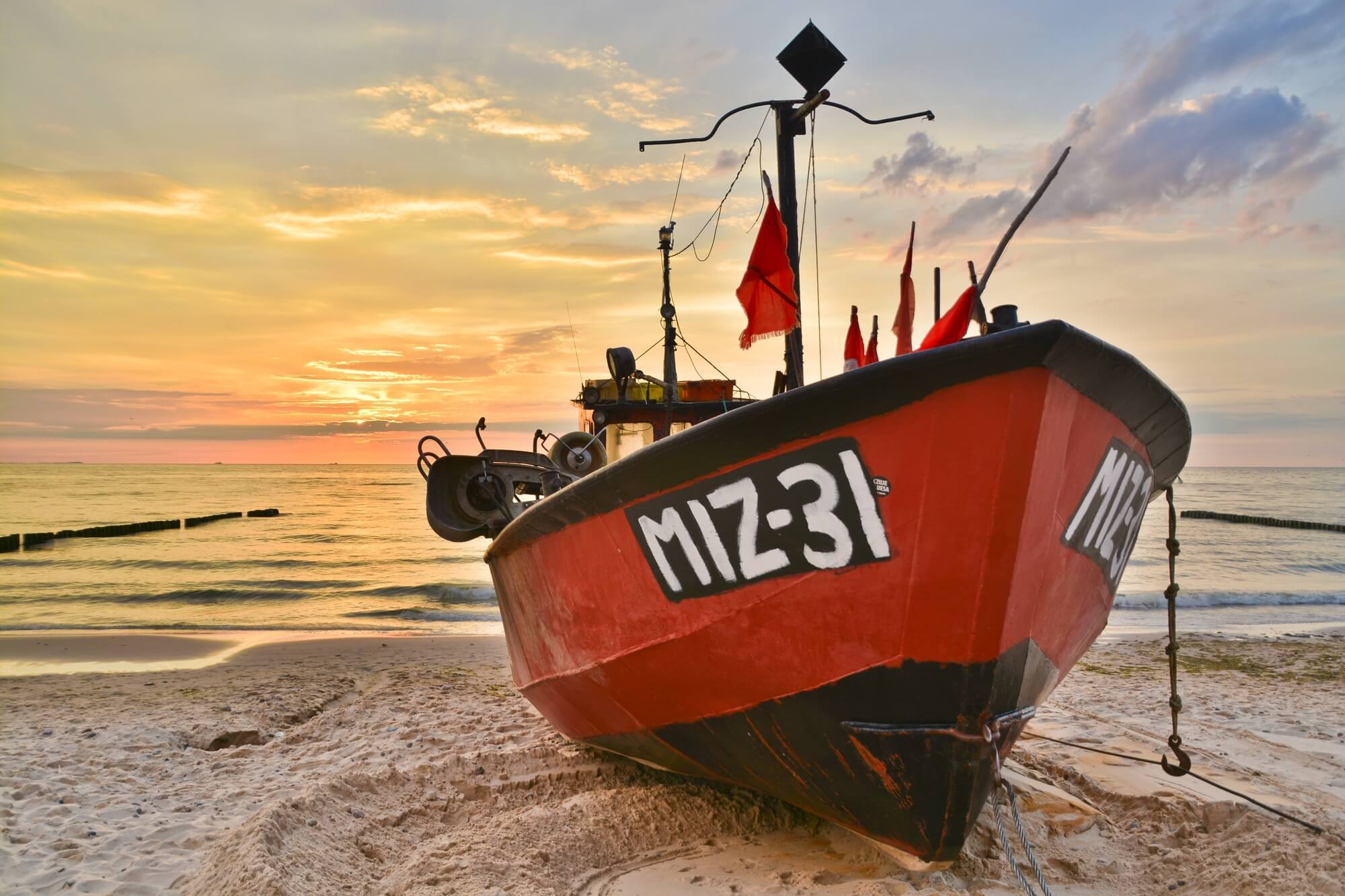 red and black boat in need of a boat lift in cocoa beach